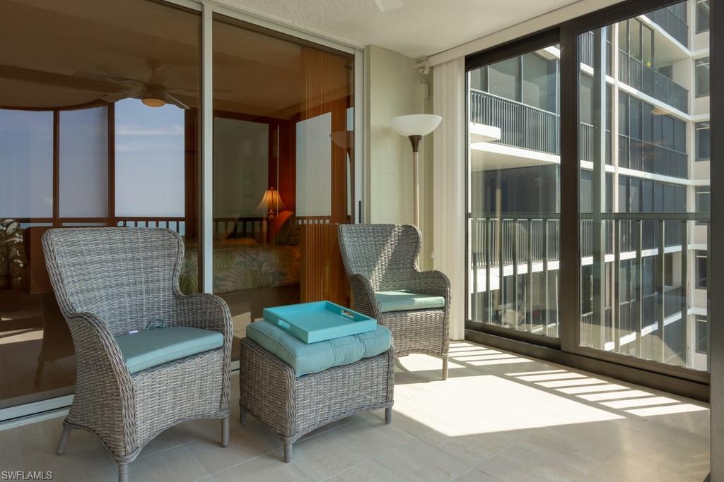 6825 Grenadier Boulevard, Unit 1505 Naples, FL 34108 - Photo 35 of 35 a living room with furniture and a floor to ceiling window