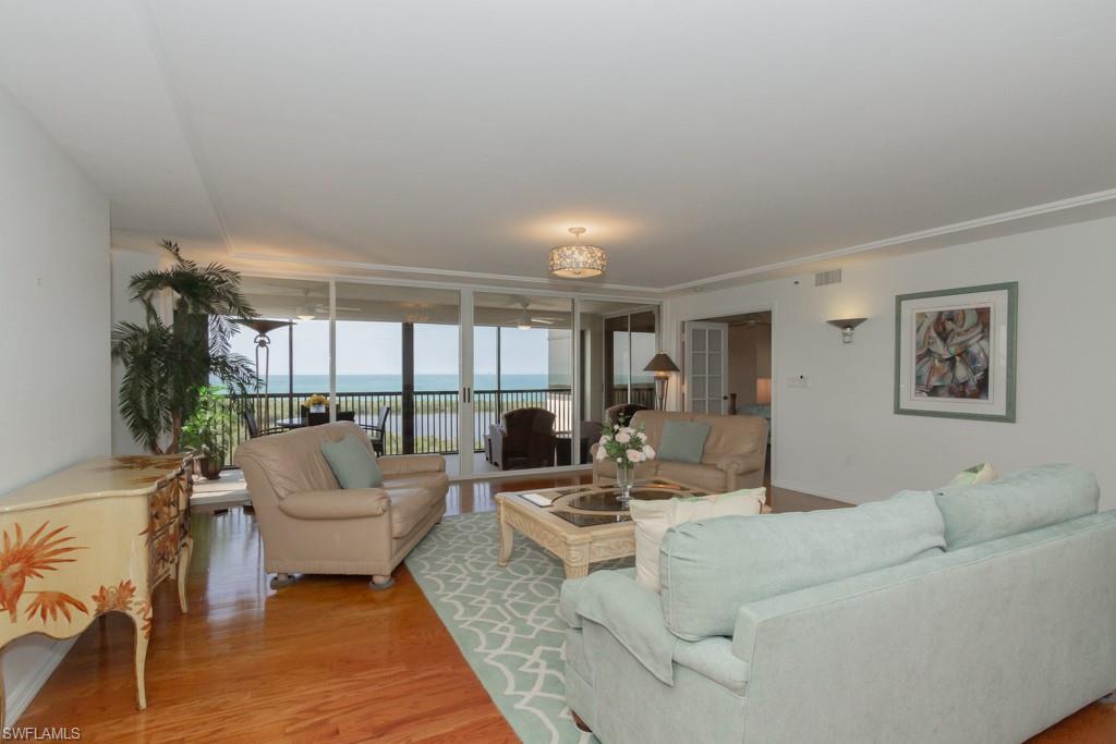 6825 Grenadier Boulevard, Unit 1505 Naples, FL 34108 - Photo 4 of 35 a living room with furniture and a large window