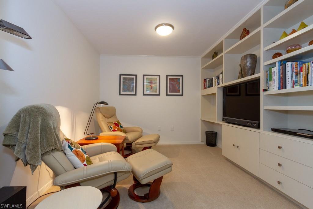 6825 Grenadier Boulevard, Unit 1505 Naples, FL 34108 - Photo 8 of 35 a living room with furniture and a flat screen tv