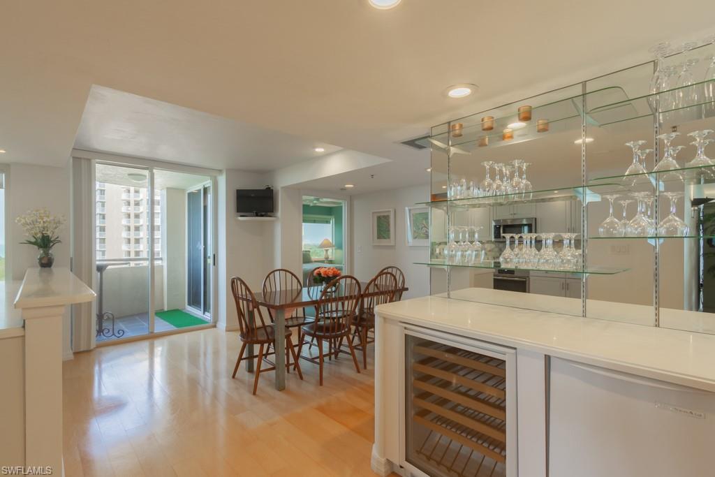 6825 Grenadier Boulevard, Unit 1505 Naples, FL 34108 - Photo 9 of 35 a view of a dining room with furniture window and wooden floor