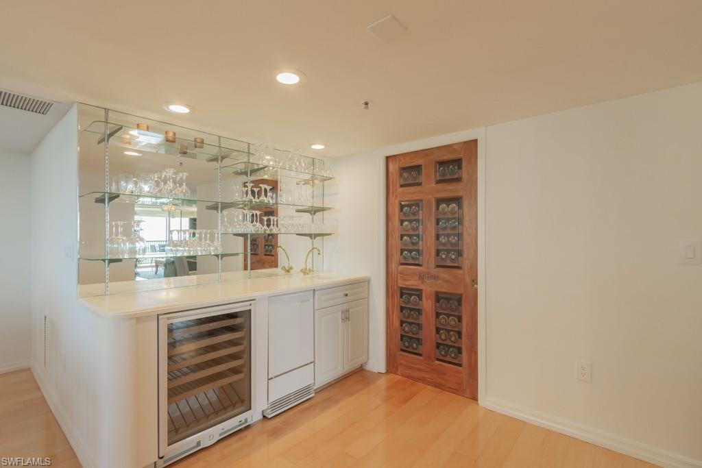 6825 Grenadier Boulevard, Unit 1505 Naples, FL 34108 - Photo 10 of 35 a kitchen with kitchen island a sink stainless steel appliances and cabinets