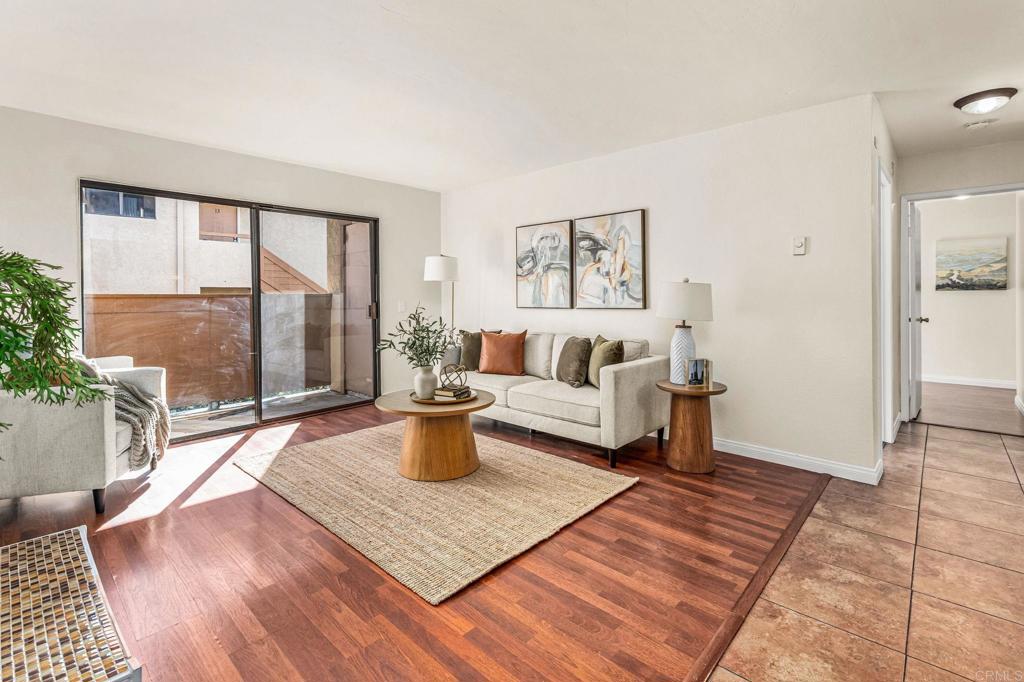 a living room with furniture a large window and a table