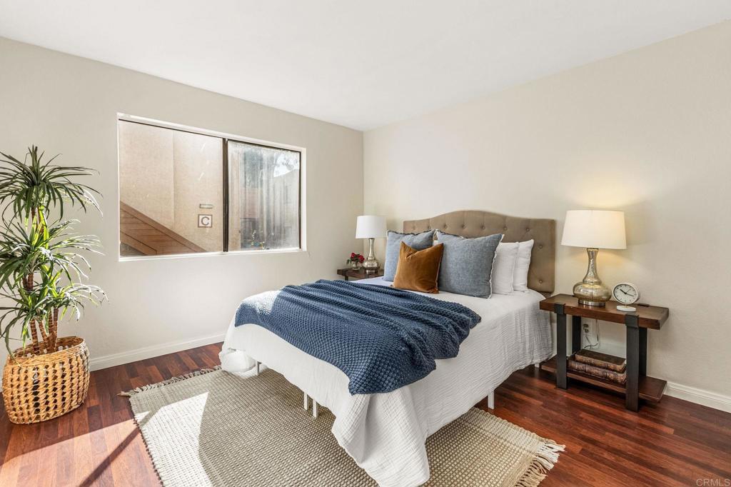 2920 Briarwood Road, Unit I1 Bonita, CA 91902 - Photo 15 of 24 a spacious bedroom with a bed and wooden floor