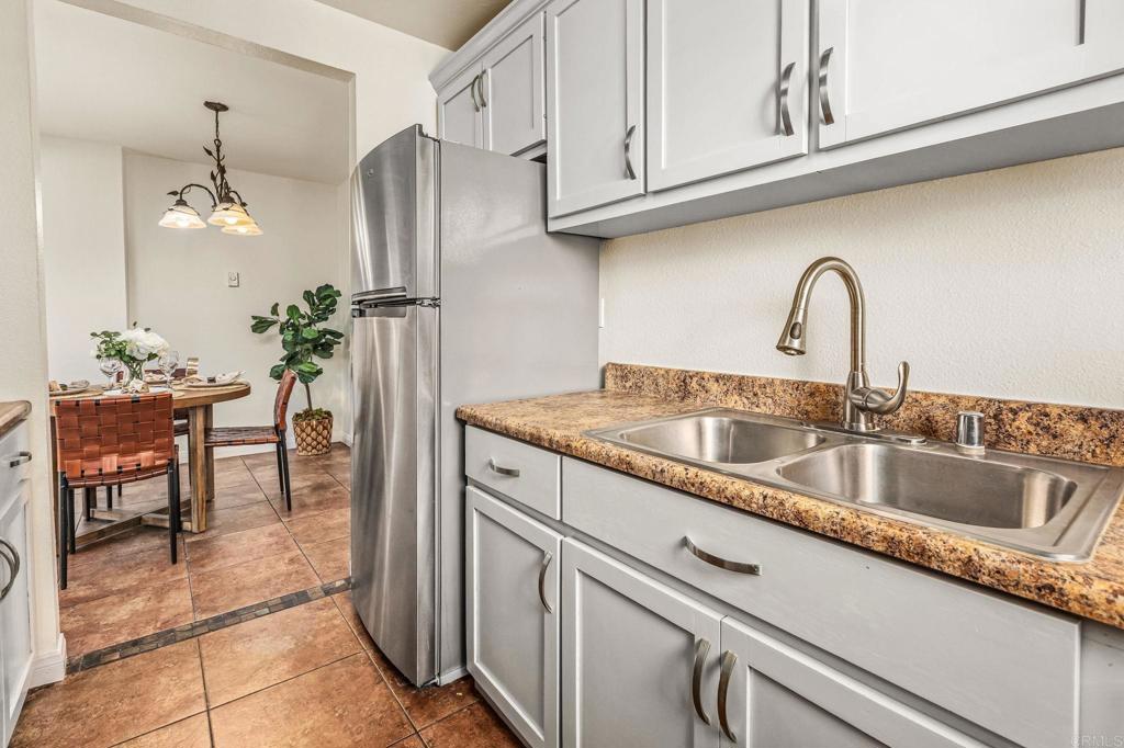 2920 Briarwood Road, Unit I1 Bonita, CA 91902 - Photo 9 of 24 a kitchen with stainless steel appliances granite countertop a sink and a refrigerator