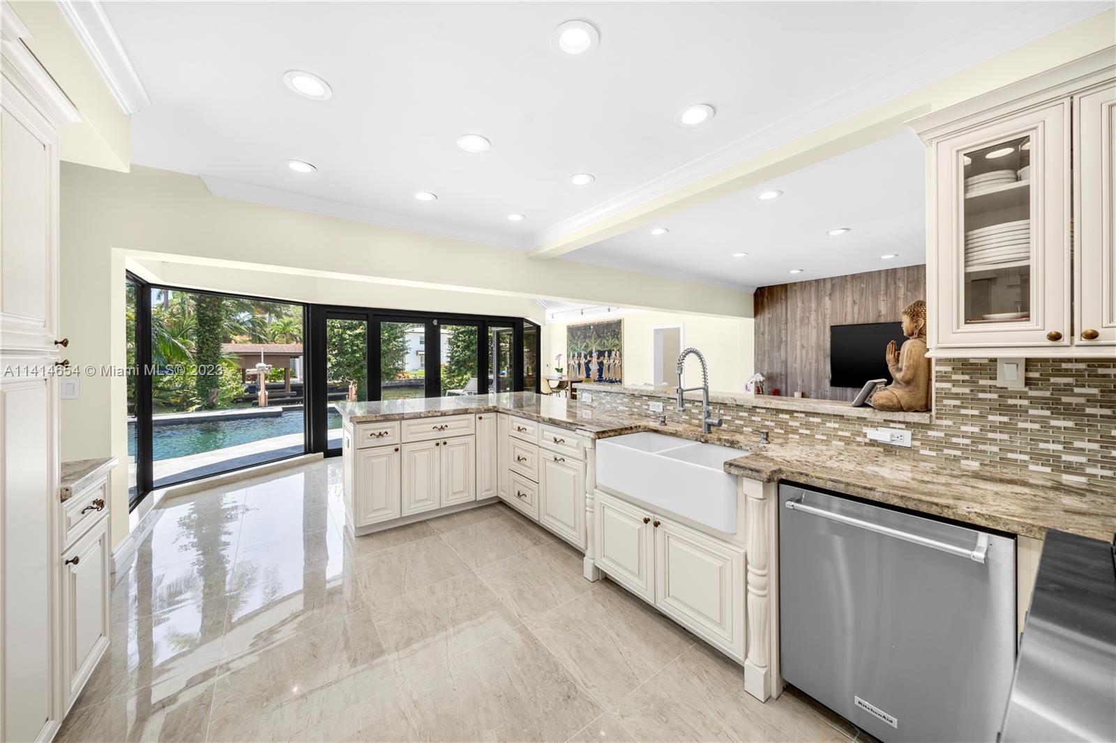 1160 Northeast 91st Street Miami, FL 33138 - Photo 12 of 33 a large white kitchen with a large window and kitchen island