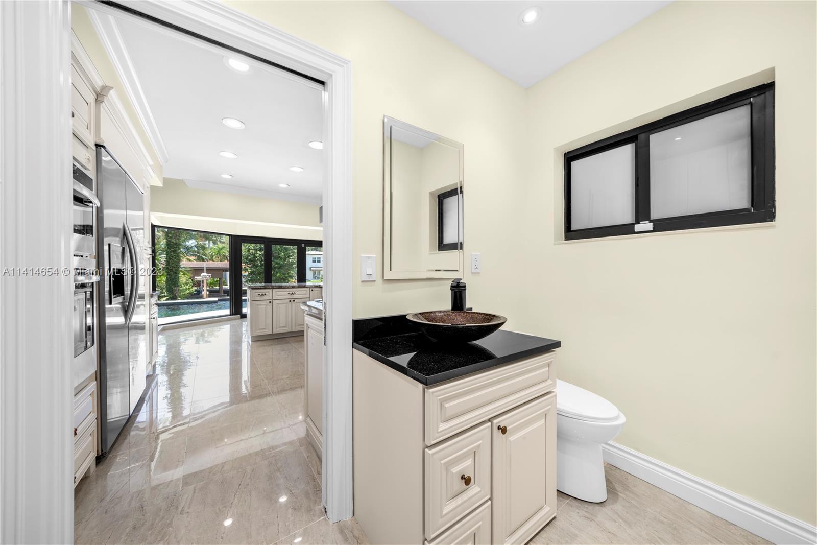 1160 Northeast 91st Street Miami, FL 33138 - Photo 13 of 33 a bathroom with a toilet sink and mirror