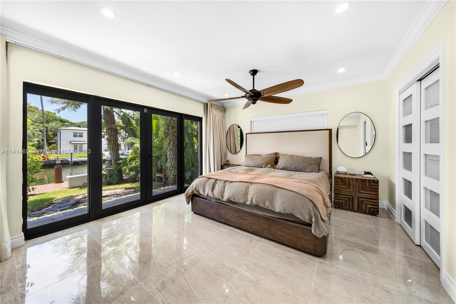 1160 Northeast 91st Street Miami, FL 33138 - Photo 14 of 33 a bedroom with a large bed and a flat tv screen