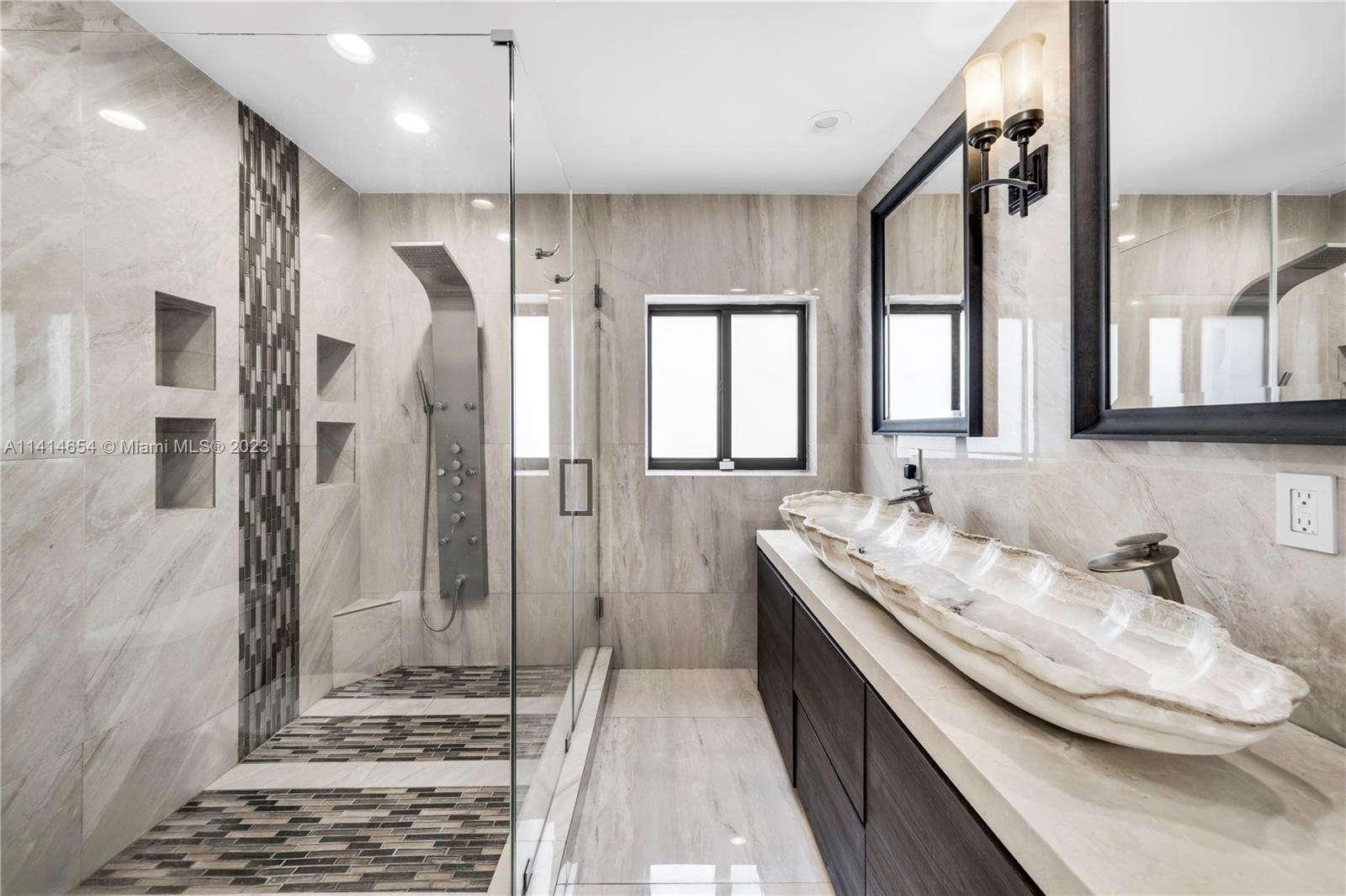 1160 Northeast 91st Street Miami, FL 33138 - Photo 19 of 33 a bathroom with a double vanity sink a mirror and a shower