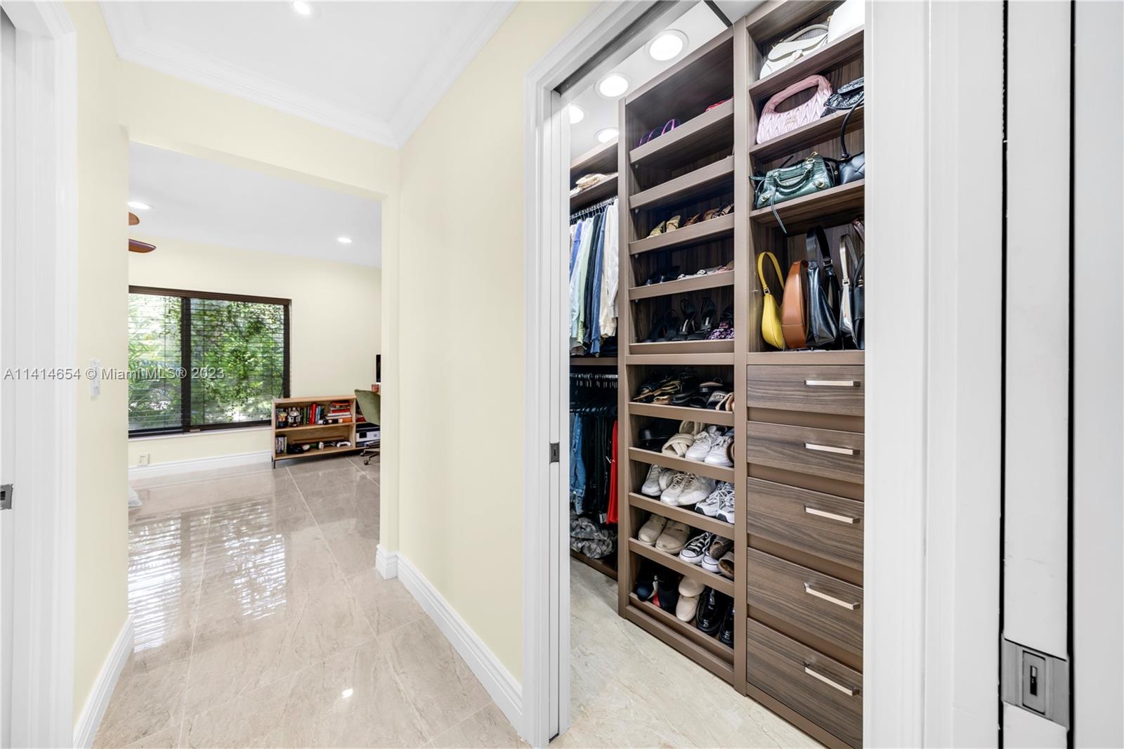 1160 Northeast 91st Street Miami, FL 33138 - Photo 20 of 33 a view of walk in closet with clothes and shoes