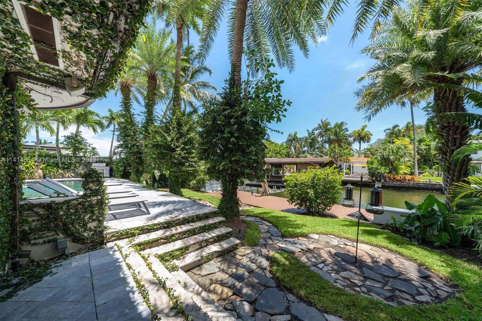 1160 Northeast 91st Street Miami, FL 33138 - Photo 30 of 33 a view of a yard with plants and palm trees