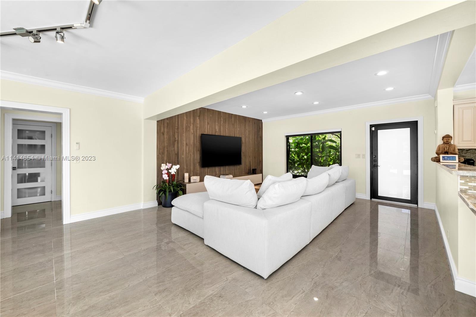 1160 Northeast 91st Street Miami, FL 33138 - Photo 4 of 33 a living room with furniture and a flat screen tv