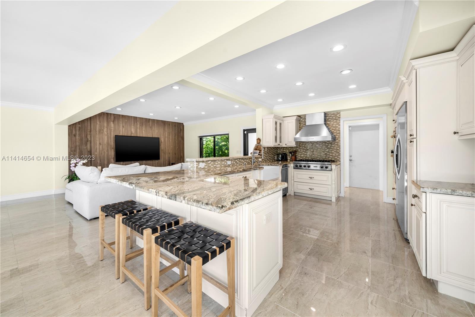 1160 Northeast 91st Street Miami, FL 33138 - Photo 10 of 33 a kitchen with stainless steel appliances kitchen island granite countertop a stove and a sink