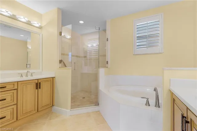 a bathroom with a bathtub sink and mirror