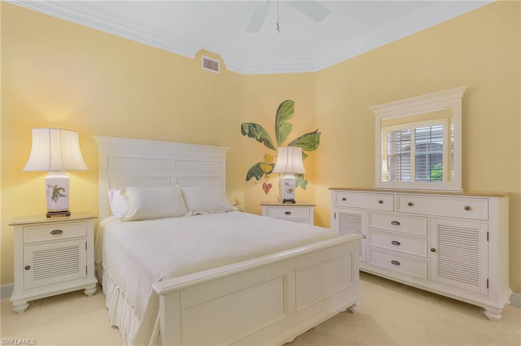 801 Regency Reserve Circle, Unit 4301 Naples, FL 34119 - Photo 14 of 26 a bedroom with a bed and a cabinets