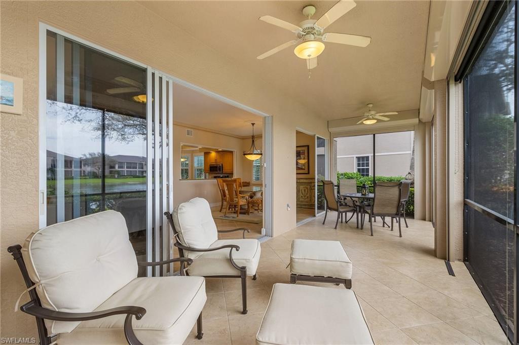 801 Regency Reserve Circle, Unit 4301 Naples, FL 34119 - Photo 16 of 26 a living room with furniture a table and chairs