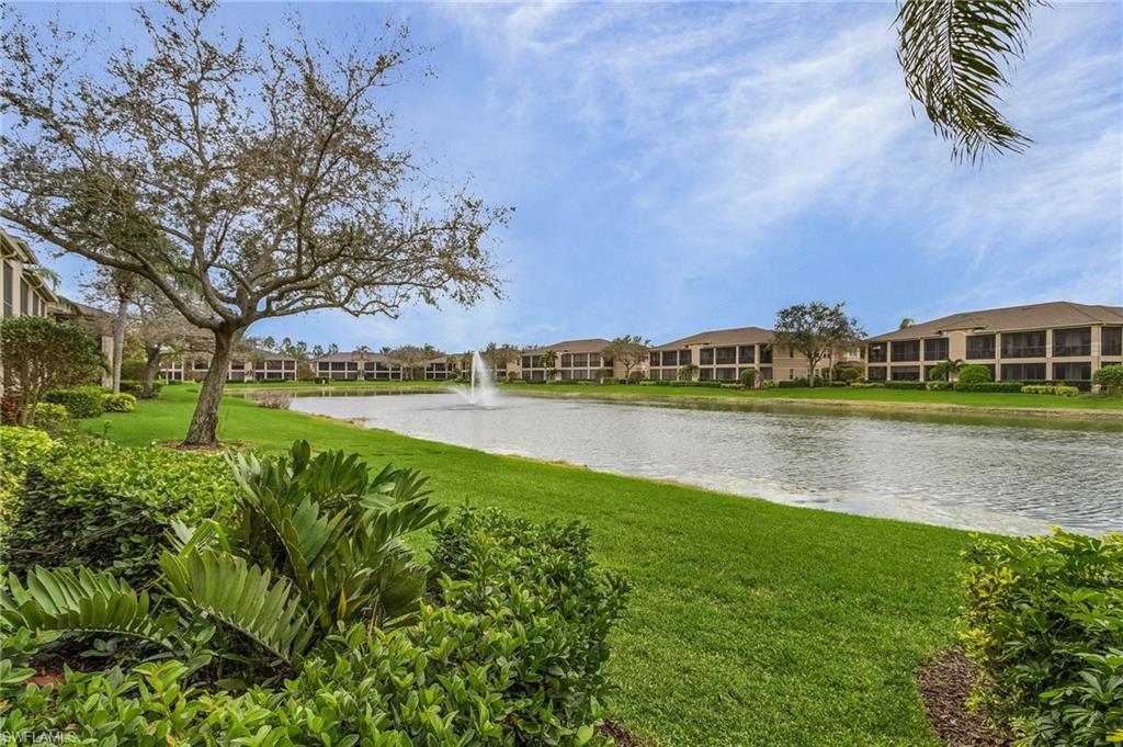 801 Regency Reserve Circle, Unit 4301 Naples, FL 34119 - Photo 20 of 26 a view of a lake with houses in the back