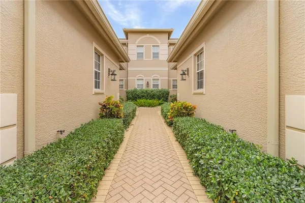 a view of a house with potted plants