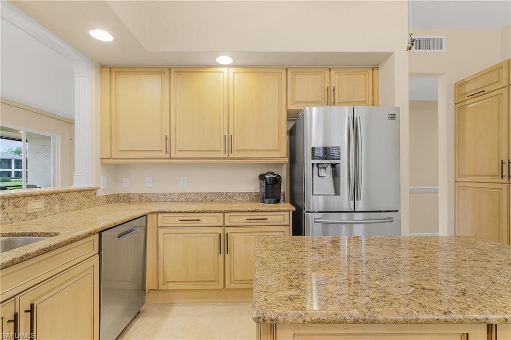 801 Regency Reserve Circle, Unit 4301 Naples, FL 34119 - Photo 8 of 26 a kitchen with a refrigerator sink and cabinets