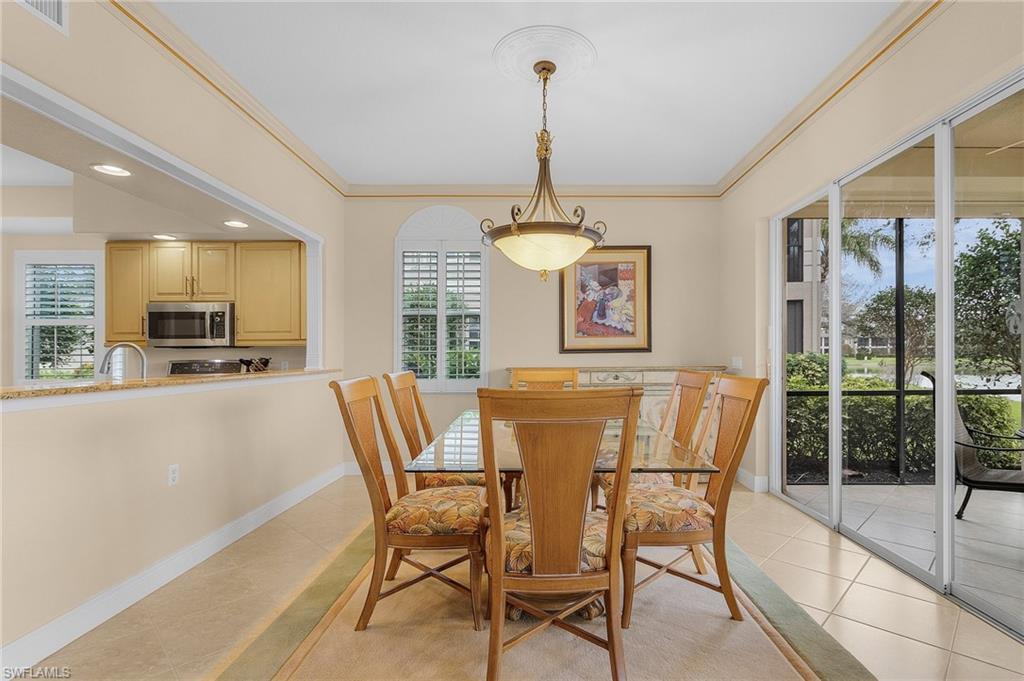 801 Regency Reserve Circle, Unit 4301 Naples, FL 34119 - Photo 9 of 26 a dining room with furniture a chandelier and window