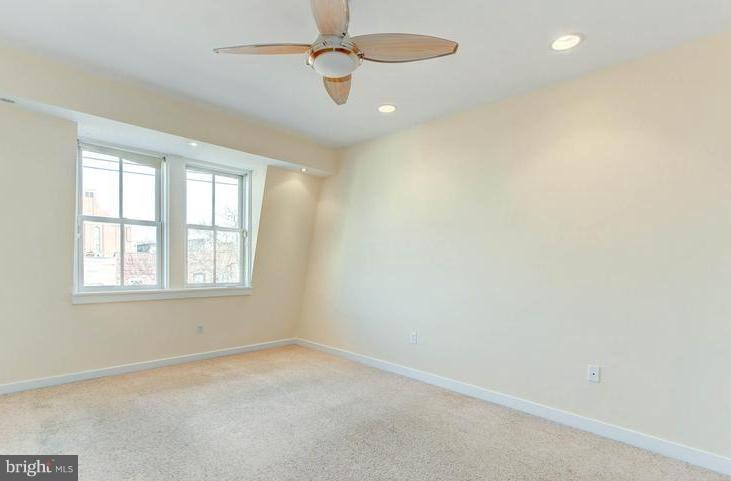 3403 Dillon Street Baltimore, MD 21224 - Photo 12 of 30 an empty room with a window and a fan