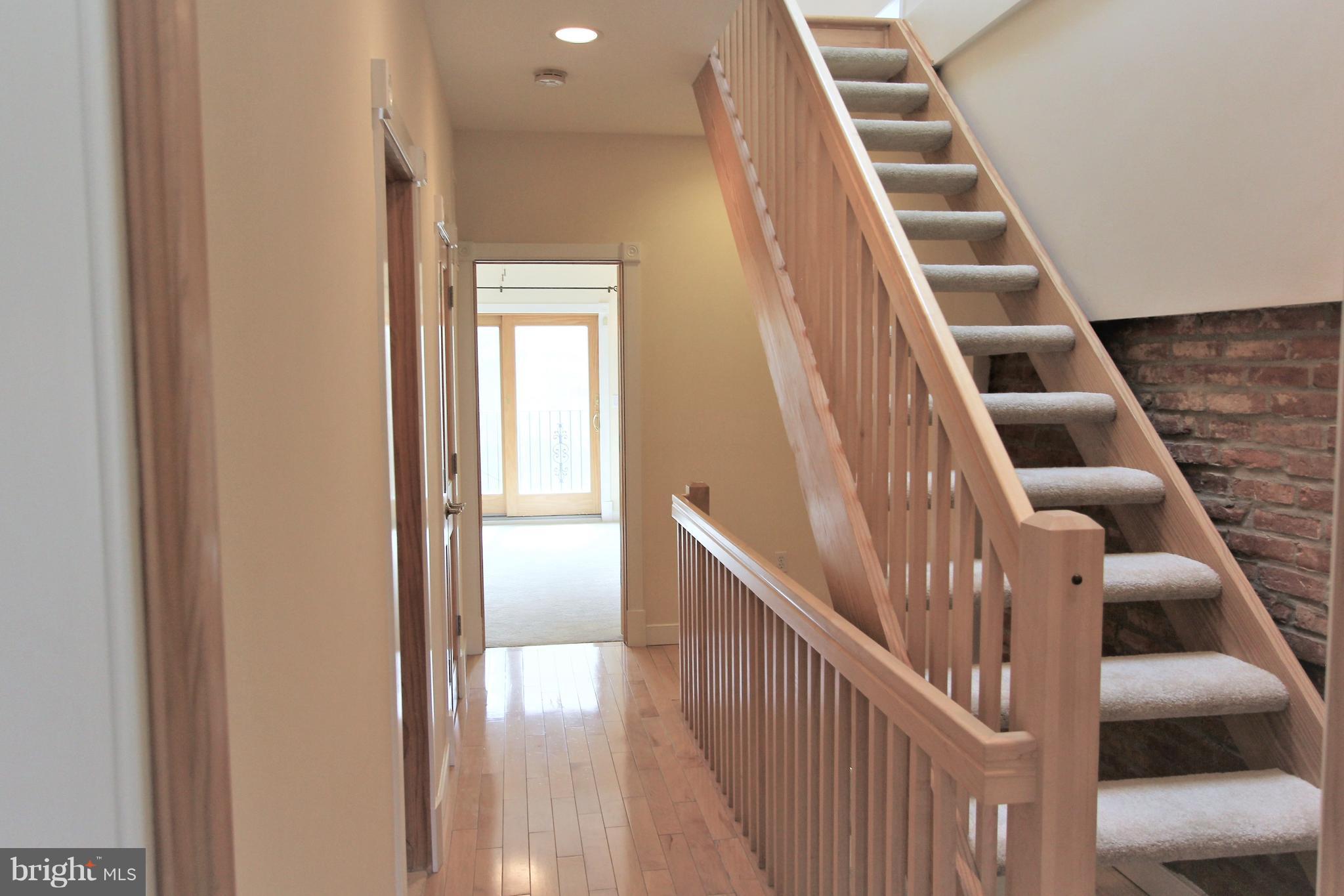 3403 Dillon Street Baltimore, MD 21224 - Photo 13 of 30 a view of staircase with wooden floor and white walls