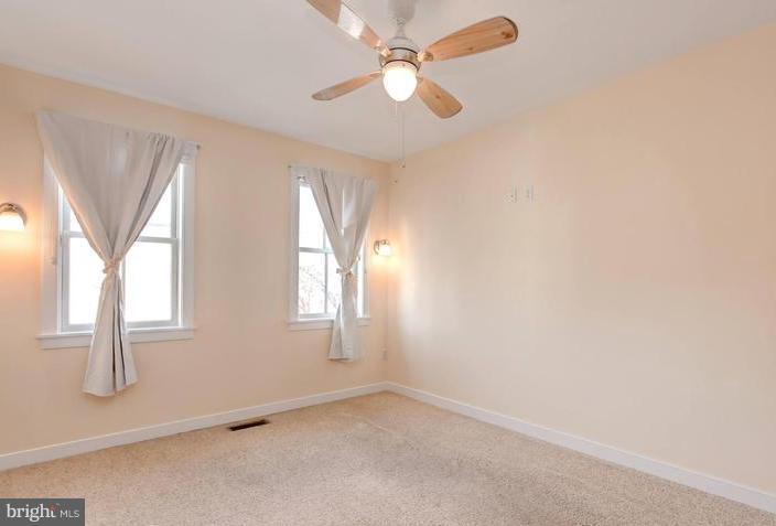 3403 Dillon Street Baltimore, MD 21224 - Photo 17 of 30 an empty room with windows and fan