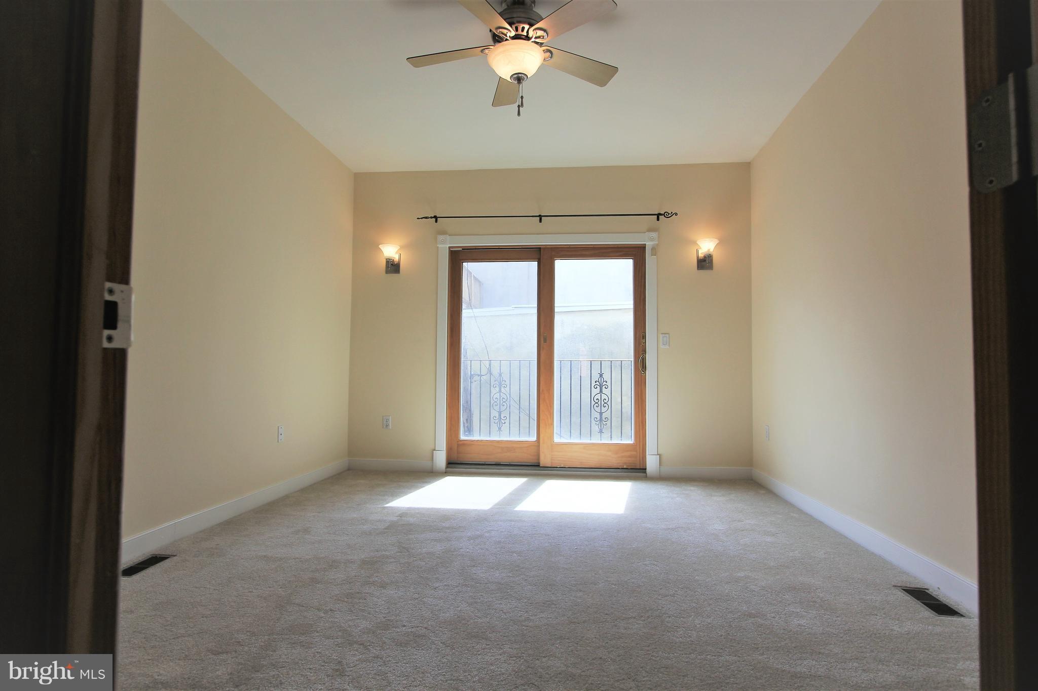 3403 Dillon Street Baltimore, MD 21224 - Photo 23 of 30 a view of a livingroom with a ceiling fan and window