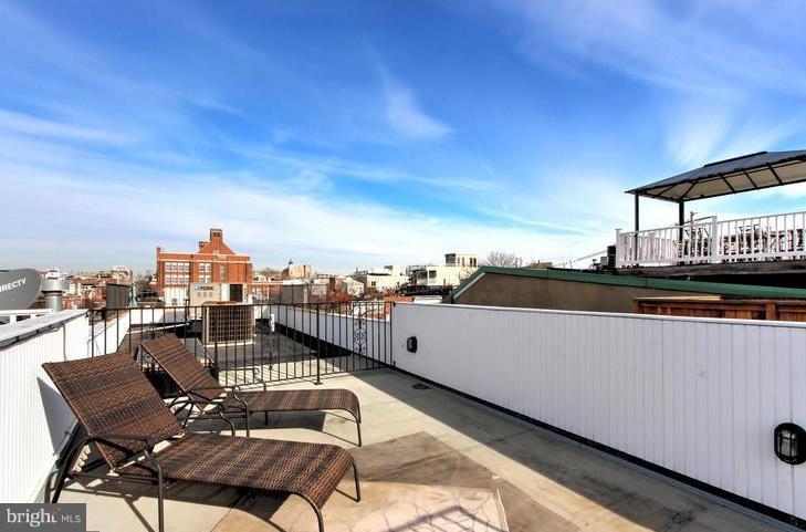 3403 Dillon Street Baltimore, MD 21224 - Photo 28 of 30 a view of a terrace with furniture and a city view