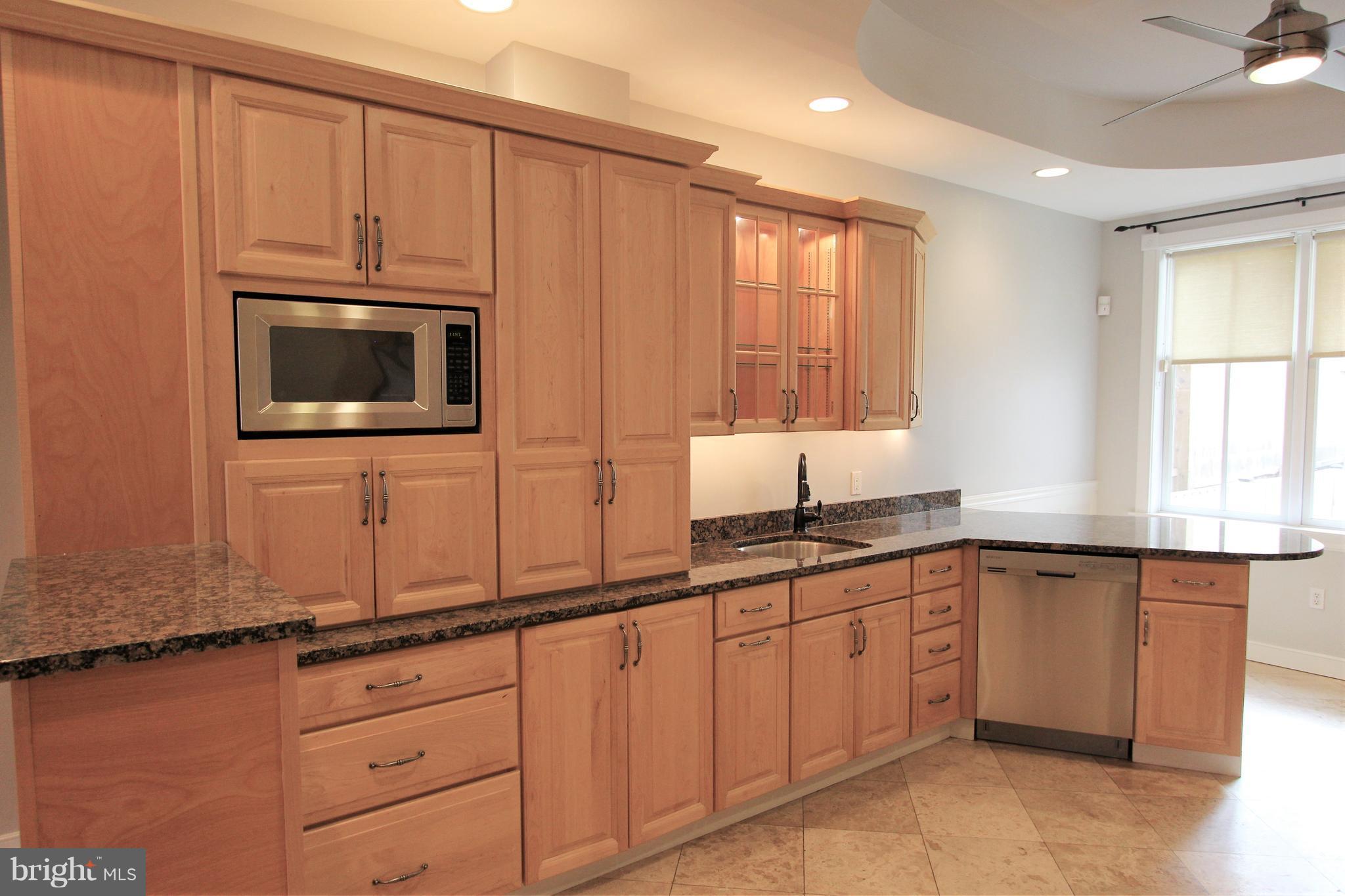 3403 Dillon Street Baltimore, MD 21224 - Photo 3 of 30 a kitchen with granite countertop cabinets stainless steel appliances a sink and window