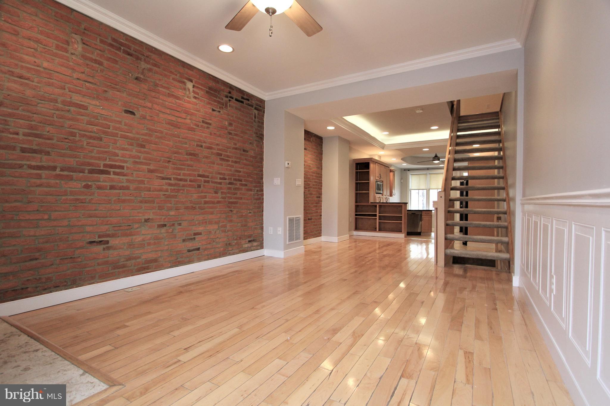 3403 Dillon Street Baltimore, MD 21224 - Photo 6 of 30 a view of empty room with wooden floor
