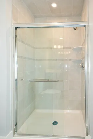 a bathroom with a glass shower door
