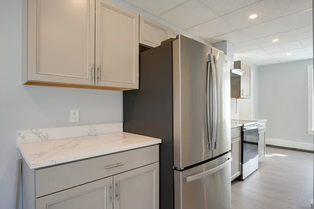 a kitchen with stainless steel appliances a refrigerator and a stove top oven