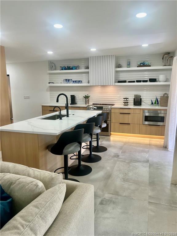 2600 South Kanner Highway, Unit D6 Stuart, FL 34994 - Photo 2 of 25 a living room with furniture and a dining table with kitchen view