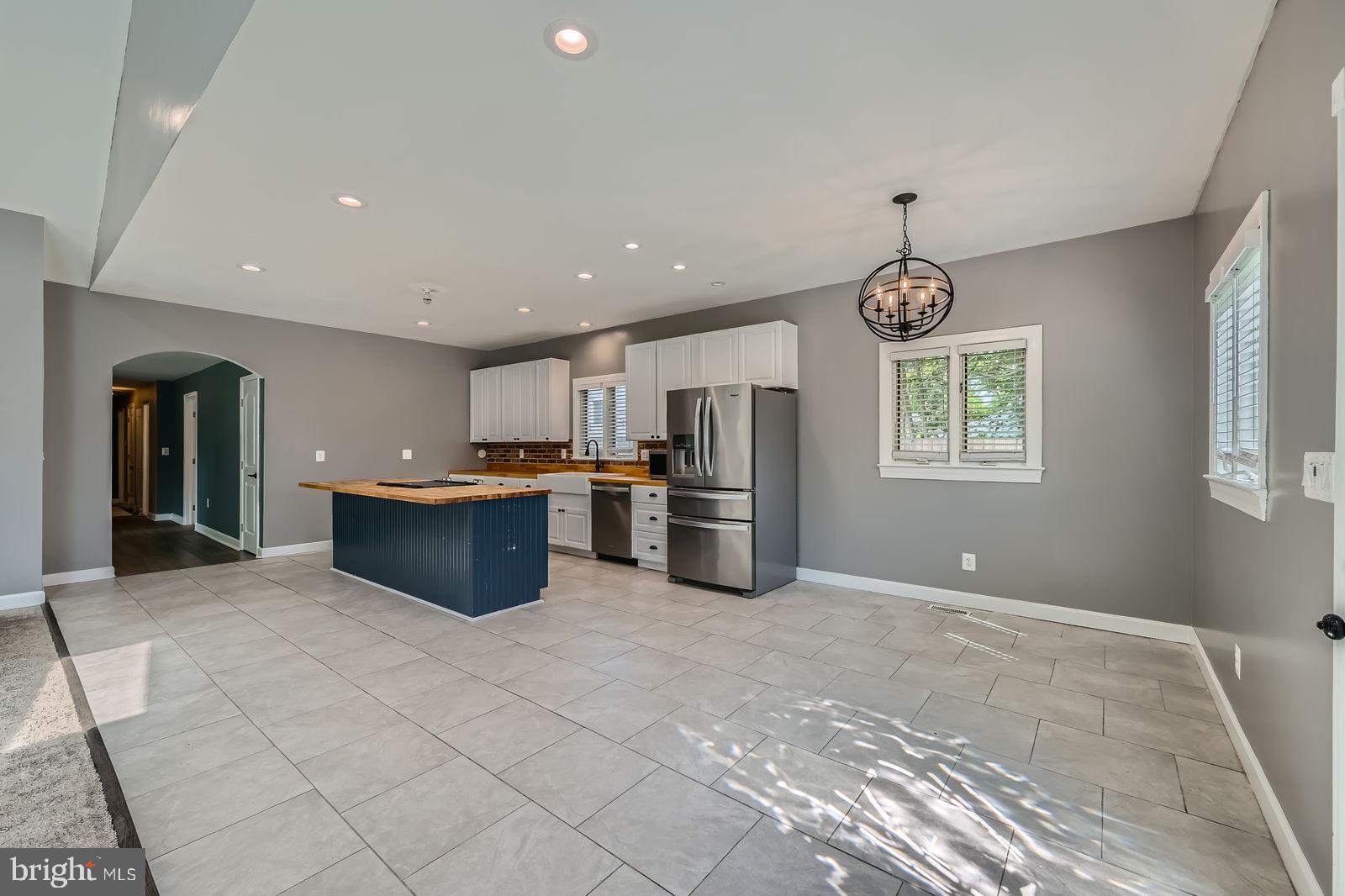 302 Haskell Drive Arnold, MD 21012 - Photo 7 of 31 a kitchen with stainless steel appliances kitchen island granite countertop a refrigerator and a sink