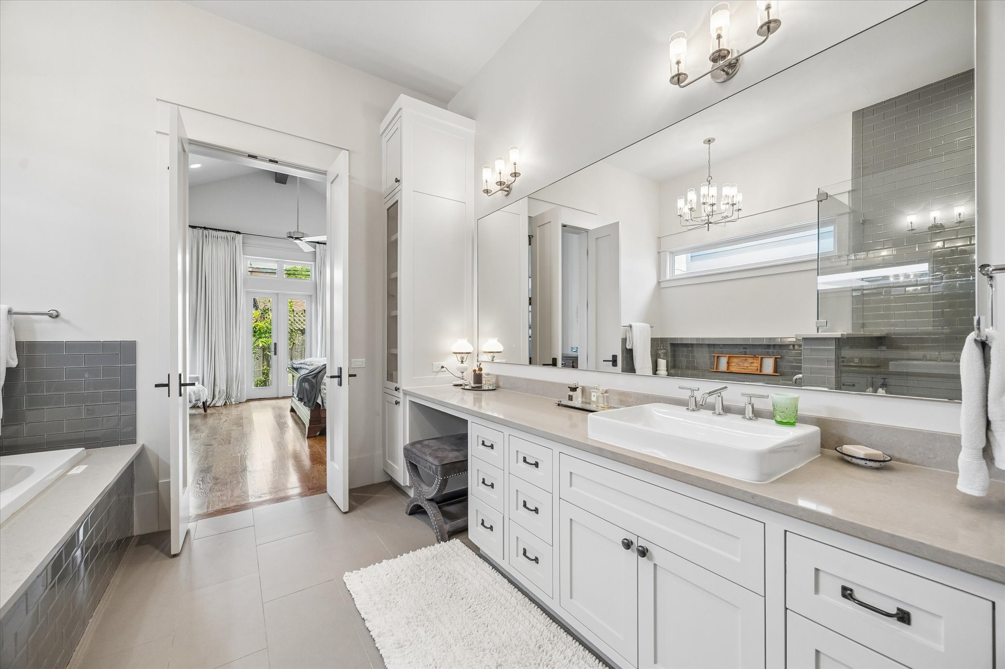 1101 Omar Street Houston, TX 77009 - Photo 22 of 46 This bright and spacious bathroom features a double vanity spaces feature generous storage, glass-front cabinetry, dual sinks, and thoughtful design details that blend beauty with everyday functionality.