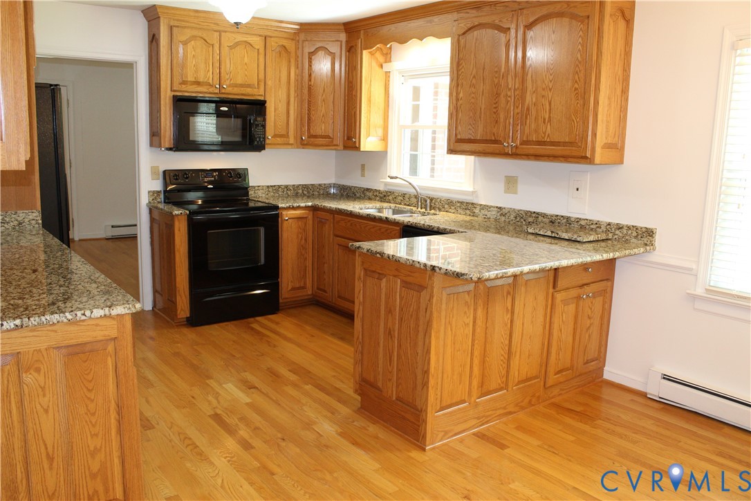 16524 Benmore Road Moseley, VA 23120 - Photo 17 of 43 a kitchen with stainless steel appliances granite countertop a stove a sink and a microwave