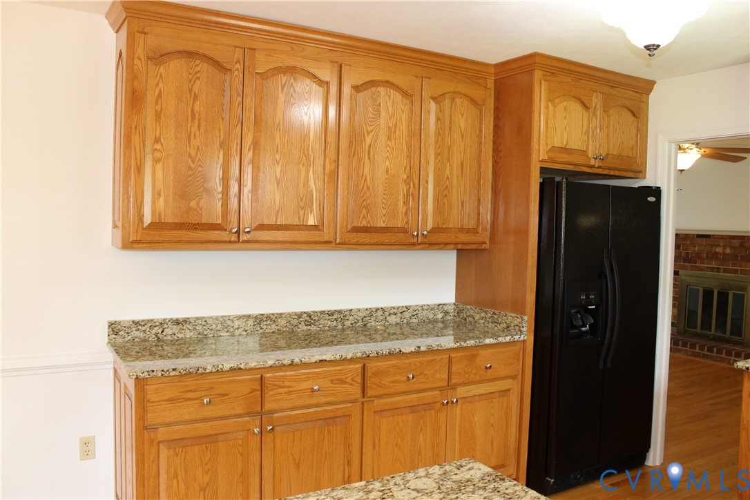 16524 Benmore Road Moseley, VA 23120 - Photo 20 of 43 a kitchen with stainless steel appliances granite countertop a refrigerator and cabinets
