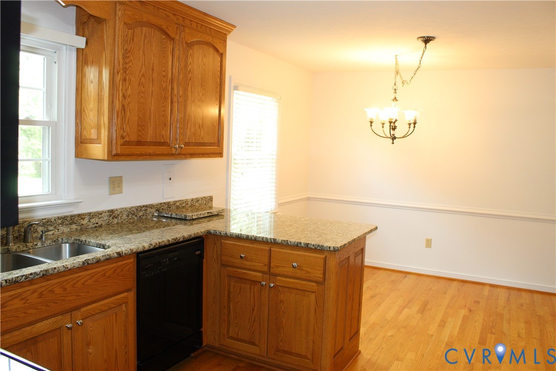 16524 Benmore Road Moseley, VA 23120 - Photo 21 of 43 a kitchen with stainless steel appliances granite countertop a sink and cabinets