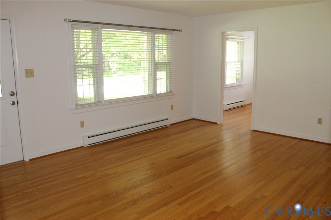 16524 Benmore Road Moseley, VA 23120 - Photo 22 of 43 a view of an empty room with wooden floor and a window