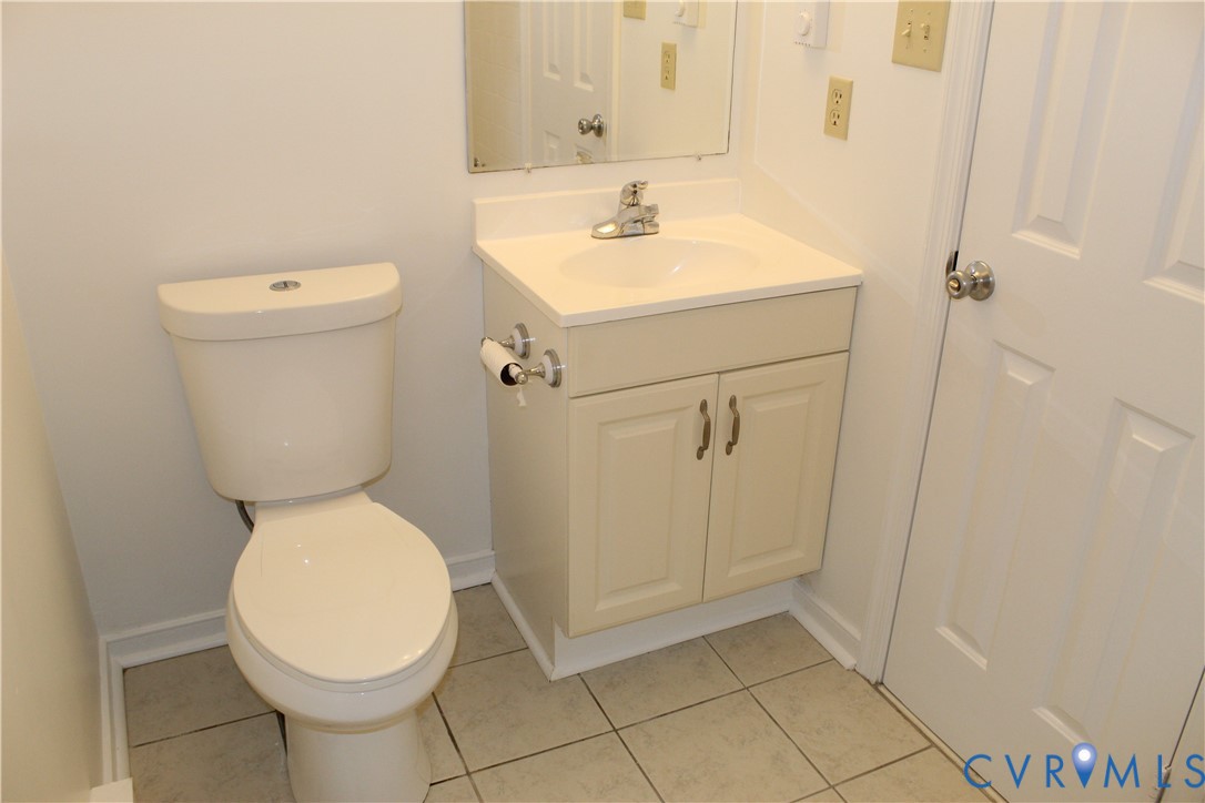 16524 Benmore Road Moseley, VA 23120 - Photo 26 of 43 a bathroom with a sink a toilet and a mirror
