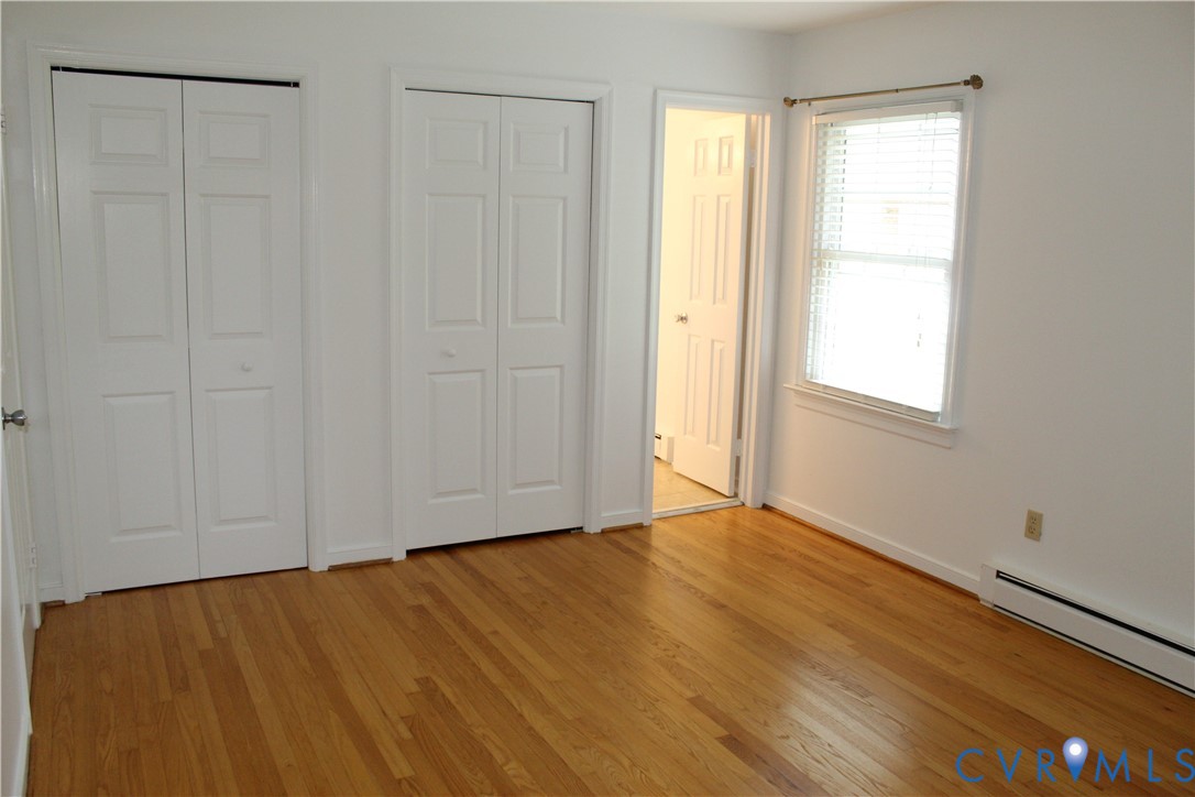 16524 Benmore Road Moseley, VA 23120 - Photo 27 of 43 a view of an empty room with wooden floor and a window