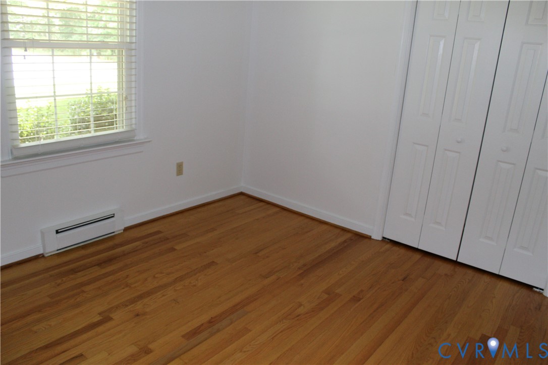 16524 Benmore Road Moseley, VA 23120 - Photo 39 of 43 an empty room with wooden floor and windows