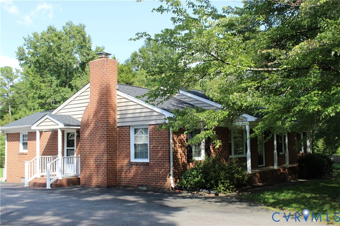 16524 Benmore Road Moseley, VA 23120 - Photo 6 of 43 a front view of a house with a garden