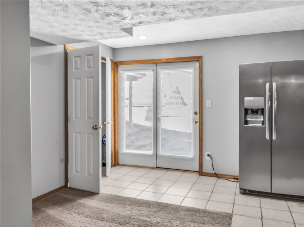 25 Callaway Springboro, OH 45066 - Photo 42 of 51 This versatile space features a stainless steel refrigerator and elegant French doors leading to the outdoors.