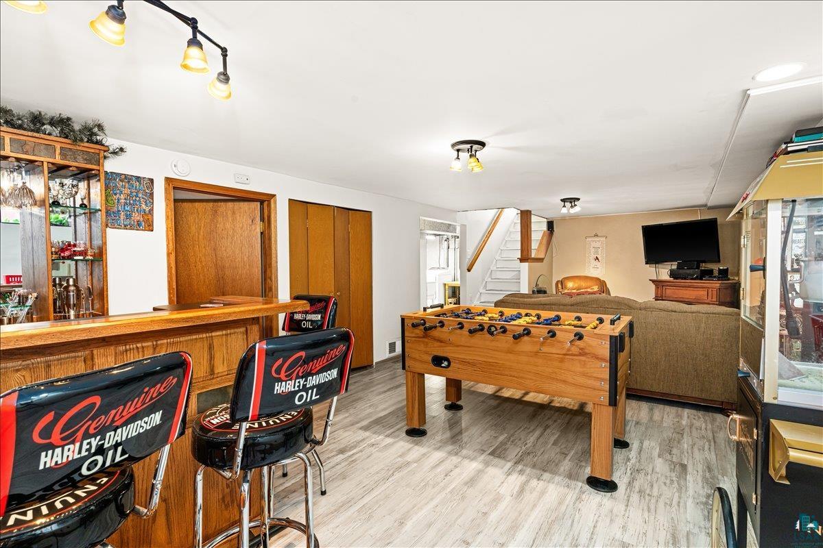 130 West Austin Street Duluth, MN 55803 - Photo 19 of 35 Finished lower level with a built-in bar, wood-finish flooring, recessed lighting, and ample space