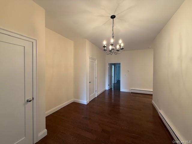 6384 Mill Street, Unit B Rhinebeck, NY 12572 - Photo 1 of 8 a view of a chandelier in big room and wooden floor
