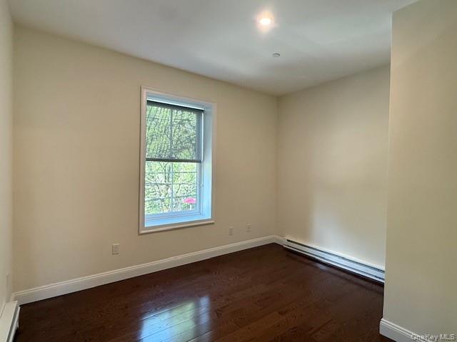 6384 Mill Street, Unit B Rhinebeck, NY 12572 - Photo 7 of 8 an empty room with wooden floor and windows