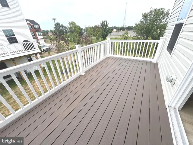 a balcony with view of lake and furniture