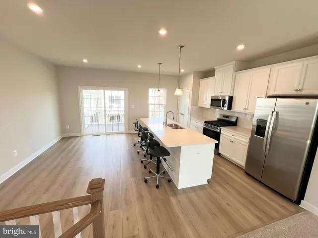 a kitchen with sink cabinets and wooden floor