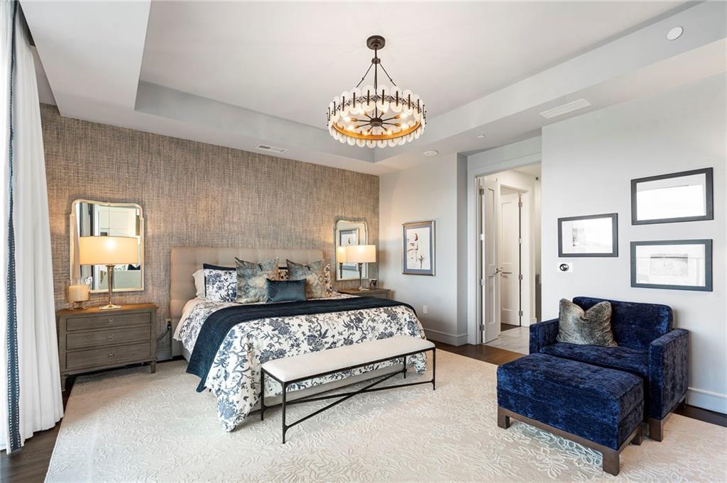 2520 Peachtree Road West, Unit 1203 Atlanta, GA 30305 - Photo 22 of 65 a bedroom with a bed and a chandelier